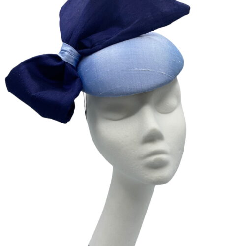 Stunning steel baby blue raw silk base headpiece with a beautiful raw silk navy side bow to finish.